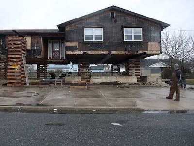 Steven Hauck, owner of SJ Hauck House Movers, looks at one of the many New Jersey homes damaged by Hurricane Sandy his company is elevating. (Credit: Denise Henhoeffer, Courier-Post, Cherry Hill, N.J.)