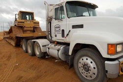 A Caterpillar D6R sits on a trailer bed of a Racon, Inc. truck. The equipment is part of the company’s $26 million auction.