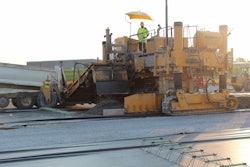 The engineering fabric shown here forms a bond breaker between the cement-treated base and the concrete pavement.