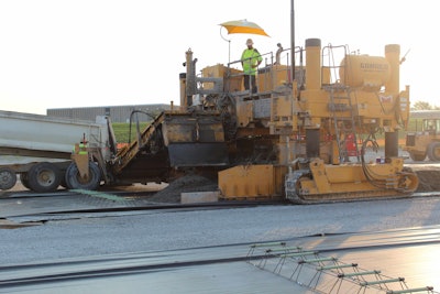 The engineering fabric shown here forms a bond breaker between the cement-treated base and the concrete pavement.