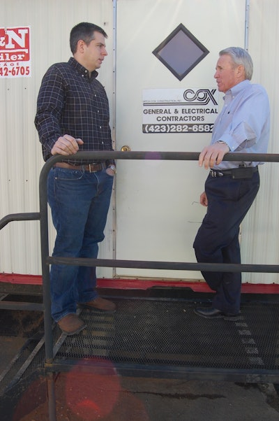 Project manager Odell Cash (left) and Mitch Cox confer on the progress of a commercial building project.
