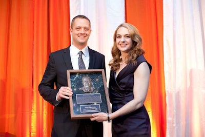 Tiffany Sewell-Howard (right), CEO of Charles Machine Works, Ditch Witch’s parent company, presents Josh Kennedy (left) with the 2012 Harold Chestnut Award.