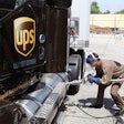 A UPS employee fueling one of the company’s LNG-powered trucks.