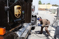 A UPS employee fueling one of the company’s LNG-powered trucks.