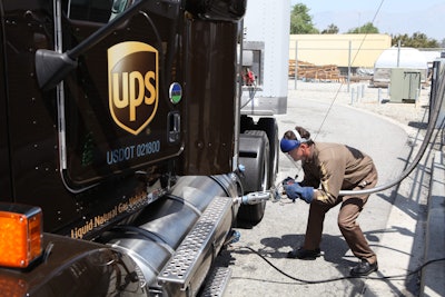 A UPS employee fueling one of the company’s LNG-powered trucks.