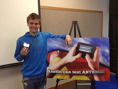 Austin Wierschke poses with a new Wisconsin advertisement. (Photo: Gannett Wisconsin Media)