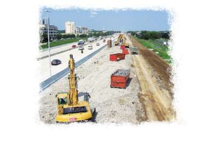 A fleet of Caterpillar excavators remove broken concrete pavement from the I-465 site.