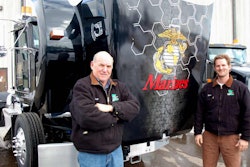 Valley Paving owner Rich Carron and his son, Brent Carron, stand beside the company’s Kenworth T800 with the U.S. Marine Corps emblem.