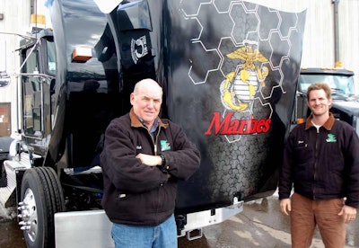 Valley Paving owner Rich Carron and his son, Brent Carron, stand beside the company’s Kenworth T800 with the U.S. Marine Corps emblem.