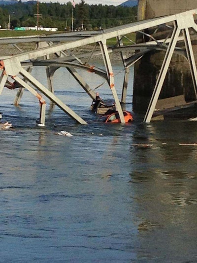 A man stands outside his truck in the Skagit River after the I-5 bridge collapse. (Photo: KING 5 News / Twitter)