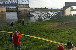 Bystanders look at the collapsed I-5 bridge north of Seattle. (Photo: Cole Wagoner / Twitter)