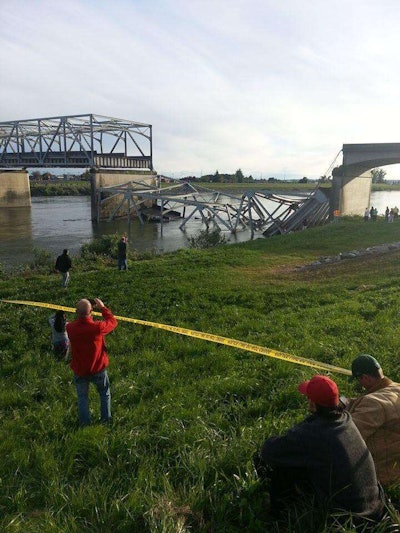 Bystanders look at the collapsed I-5 bridge north of Seattle. (Photo: Cole Wagoner / Twitter)
