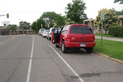 A vehicle opens its door into the bike lane. (Photo: Mike Juvrud / Flickr)