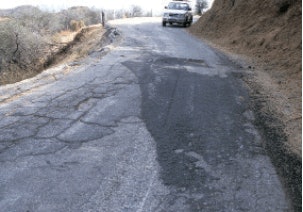 No patching can cure severe fatigue cracking, which indicates profound base failure; road ultimately was in-place foam-recycled with thin overlay.