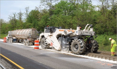 Revealed, failed base of Virginia I-81 is stabilized in situ using hydrated lime kiln dust; existing asphalt courses above were foam-recycled at portable cold mix plant adjacent to project and placed over this stabilized base.