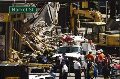 Workers search through the rubble of a collapsed building in Philadelphia. Credit: Reuters/Eduardo Munoz