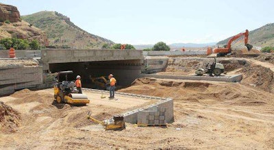 UDOT crews work on an I-84 overpass, using geosynthetic reinforcement and soil integration in place of steel pylons and concrete. (Photo: Jeffrey D. Allred, Deseret News)