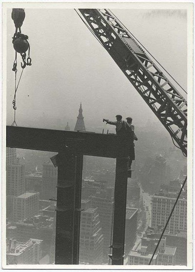 Workers stand on the edge of a beam during construction of the Empire State Building. Credit: Lewis Wickes Hine