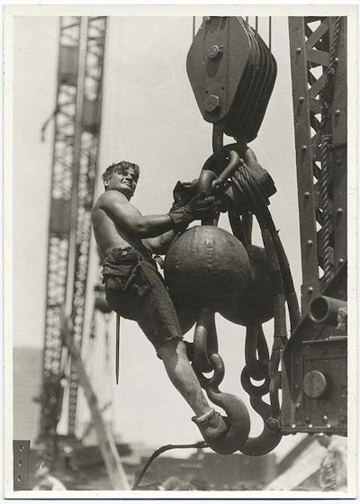 A worker rides a crane hook during construction of the Empire State Building. Credit: Lewis Wickes Hine