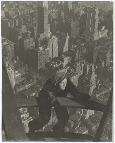 An Empire State Building worker clings to a piece of steel high above New York City. Credit: Lewis Wickes Hine