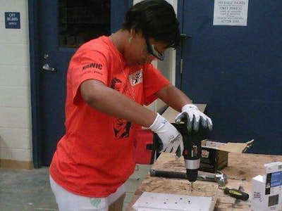 Shere Tolbert, 14, uses a drill at the Rosie’s Girls construction camp in Cincinnati. Credit: WCPO.com