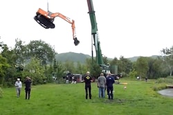 crane rescues excavator