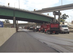 (Left) A line of asphalt-filled trucks are ready to load the paver on the I-710 long-life asphalt pavement project. (Right) The completed lanes on the I-710, pictured here, are part of a rehabilitation project that is a series of projects stretching several years that could ultimately cost $650 million when the final tally is complete.