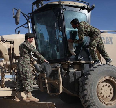 Afghan National Army soldiers clean motor graders