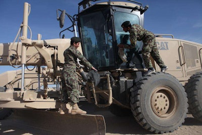 Afghan National Army soldiers from the 215th Corps’ Engineer Kandak clean their motor graders during the Heavy Equipment Maintenance Course at the engineer lot on Camp Shorabak, Helmand Province, Afghanistan on Nov. 2. More than 40 soldiers are learning to become certified mechanics through the six-month course designed to certify soldiers as mechanics. Credit: Sgt. Bryan Peterson