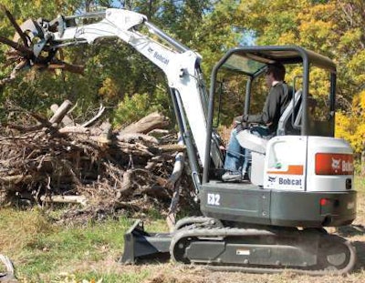The tine grapple on this Bobcat E32 makes quick work of land clearing jobs.