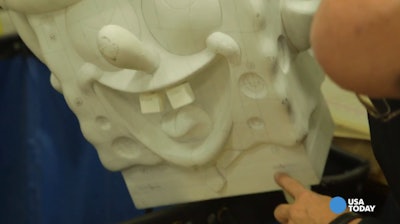 Studio Vice President John Piper shows off a model of the Spongebob Squarepants balloon marked up with schematics. Credit: Bill Delano/USA Today