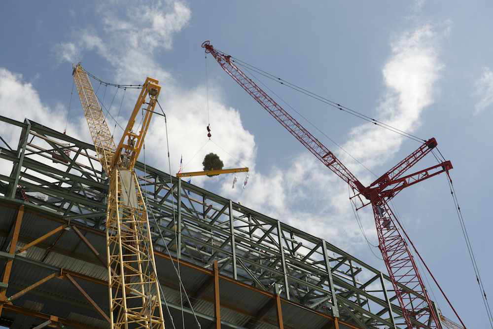 Why do construction crews put Christmas trees on top of “topped out ...