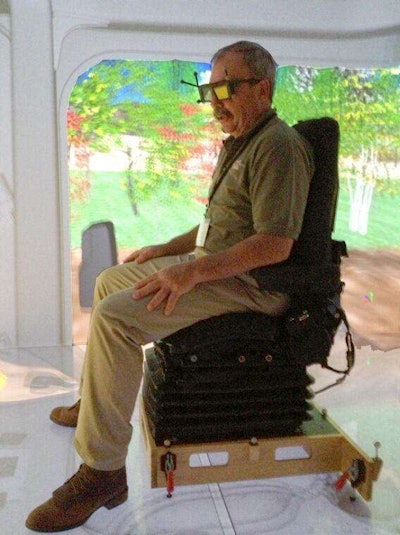 Phil Newberry sits in the Cat Immersive Visualization Center.