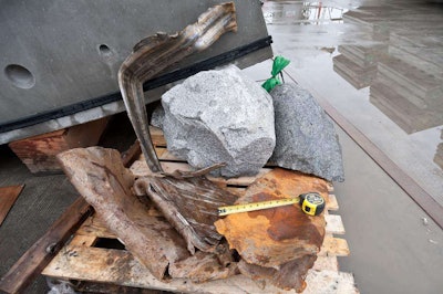 A pair of large boulders and a section of flattened pipe after being chewed up by Bertha. This debris made it all the way through Bertha’s conveyor system. Credit: WSDOT Flickr
