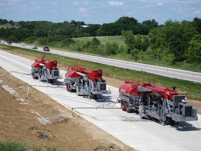 Spreading should begin a minimum of 1 foot from the shoulder, with each pass of the grinder moving the spread¬ing operation farther down the slope to ensure no build-up of grinding residue.