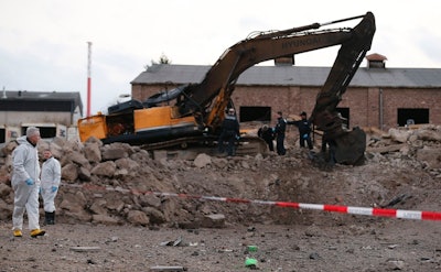 Police examine a construction disposal site where a World War II bomb exploded in Euskirchen, Germany. Credit: Frank Augstein/AP