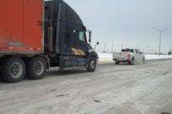 Indiana State Police help a truck stuck on the Interstate. Police and Indiana Department of Transportation crews had to shovel sand under truck tires to help them gain traction.