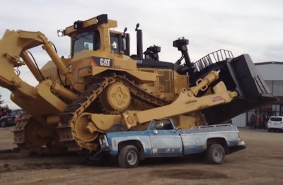 Cat D11T runs over old pickup truck
