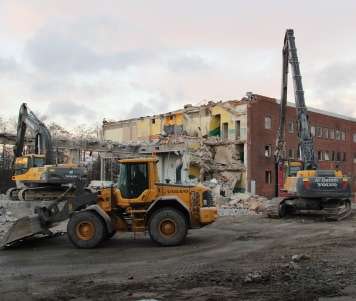 A Volvo L90F wheel loader scoops up debris during the demolition of a 175-year-old Volvo CE plant.