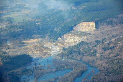 A landslide occurred near Oso, Washington on Saturday, covering a portion of State Route 530. (Photo Credit: @WSDOT / Twitter)