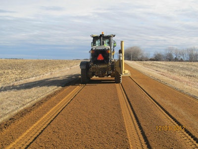 After injection of 38-percent liquid calcium chloride, the road base was compacted and then bladed to a 2.5-percent crown.