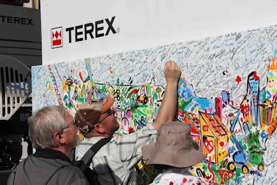 ConExpo-Con/Agg 2014 attendees add their fingerprints and signatures to the “I Make America” painting. (Photo courtesy of Terex)