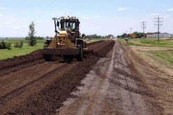 Workers applied three inches of aggregate to the road surface in the early stages of the Kosciusko County road base stabilization project.