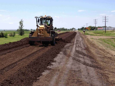 Workers applied three inches of aggregate to the road surface in the early stages of the Kosciusko County road base stabilization project.