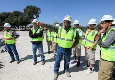 Project superintendent Dale Nieder takes Highlands High School students on a tour of their new buildings. Credit: San Antonio Express-News