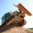 A patron of Extreme Sandbox drives a Cat D5K over a large mound. Credit: Extreme Sandbox