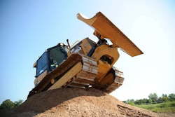 A patron of Extreme Sandbox drives a Cat D5K over a large mound. Credit: Extreme Sandbox