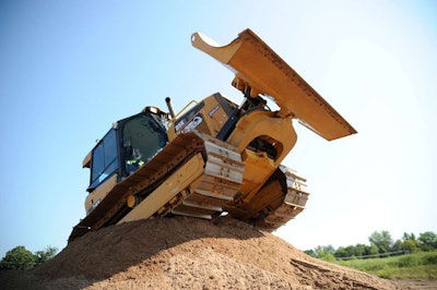 A patron of Extreme Sandbox drives a Cat D5K over a large mound. Credit: Extreme Sandbox