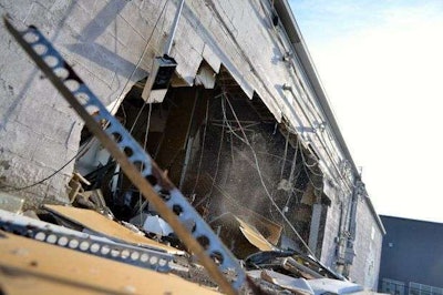 The hole in the back of a strip mall in Cleveland left by a stolen wheel loader. Credit: Cory Shaffer/Cleveland.com