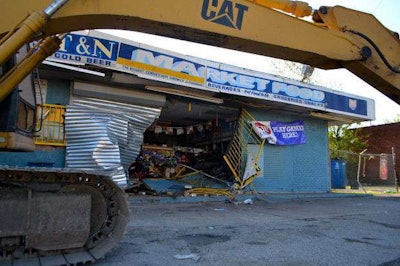 A stolen Cat 320 excavator in front of the market in Cleveland thieves used to break in. Credit: Cory Shaffer/Cleveland.com